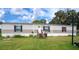 Mobile home with a beige exterior, steps, and American flag at 1815 Christy Ln, Lakeland, FL 33801