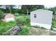Aerial view of a mobile home with a large yard and outbuildings at 1815 Christy Ln, Lakeland, FL 33801