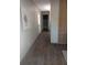 Long hallway with light walls and wood-look floors at 1815 Christy Ln, Lakeland, FL 33801