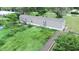 Single wide manufactured home with overgrown backyard at 1815 Christy Ln, Lakeland, FL 33801