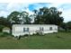 Single-wide manufactured home with a large backyard at 1815 Christy Ln, Lakeland, FL 33801