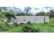 Tan mobile home with a small porch and backyard at 1815 Christy Ln, Lakeland, FL 33801