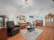 Living room with comfortable seating, a wood floor, and access to the lanai at 716 Challenger Ave, Davenport, FL 33897