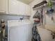 Laundry room with washer, dryer, and overhead storage at 716 Challenger Ave, Davenport, FL 33897