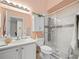 Updated bathroom with a walk-in shower and white cabinetry at 716 Challenger Ave, Davenport, FL 33897