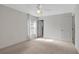 Spacious bedroom with carpet, ceiling fan, and access to bathroom at 816 W Hancock St, Lakeland, FL 33803