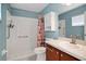 Bathroom with shower/tub combo, tile flooring and wood vanity at 816 W Hancock St, Lakeland, FL 33803