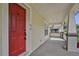 Side porch with red door and view of the backyard at 816 W Hancock St, Lakeland, FL 33803