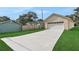 Single car garage with driveway and grassy yard at 816 W Hancock St, Lakeland, FL 33803