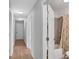 Hallway with light wood floors and doors to rooms at 816 W Hancock St, Lakeland, FL 33803