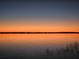 Stunning sunset over lake with calm water and reeds at 3350 Crump Rd, Winter Haven, FL 33881