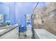 Charming bathroom with blue walls, granite countertop and bathtub at 2931 Chickasaw Cir, Haines City, FL 33844