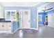 Bright entry with white door, wood-look floors, and blue walls at 2931 Chickasaw Cir, Haines City, FL 33844