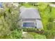 Home's backyard features a screened-in pool and lush greenery at 2931 Chickasaw Cir, Haines City, FL 33844