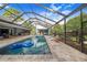 Inviting pool area with covered patio, lounge chairs, and floating rafts at 2931 Chickasaw Cir, Haines City, FL 33844