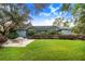 View of the house from backyard showcasing the pool and landscaping at 2931 Chickasaw Cir, Haines City, FL 33844