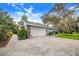 Attached garage with paved driveway and landscaping at 2931 Chickasaw Cir, Haines City, FL 33844
