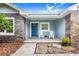 Front porch of a one-story home with blue exterior at 2931 Chickasaw Cir, Haines City, FL 33844