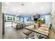 Modern kitchen with a large island, white cabinets, and an adjacent farmhouse dining table at 2931 Chickasaw Cir, Haines City, FL 33844