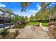 Outdoor living space with fire pit, lush landscaping, and a view of the pool at 2931 Chickasaw Cir, Haines City, FL 33844