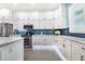 Modern kitchen with white cabinets and blue tile backsplash at 2931 Chickasaw Cir, Haines City, FL 33844