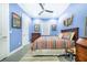 Cozy bedroom with blue walls, striped bedding, and wood furniture at 2931 Chickasaw Cir, Haines City, FL 33844