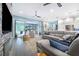 Bright living room with a sectional sofa, sliding doors opening to a pool view, and a stone fireplace at 2931 Chickasaw Cir, Haines City, FL 33844