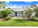 One-story home with blue exterior and landscaped yard at 2931 Chickasaw Cir, Haines City, FL 33844