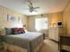 Bedroom with a comfortable bed, dresser, and ceiling fan at 191 Sweet Cir, Winter Haven, FL 33884