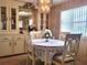Charming dining room with built-in hutch and lace tablecloth at 191 Sweet Cir, Winter Haven, FL 33884