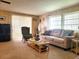 Living room with sofa, chair, coffee table, and TV at 191 Sweet Cir, Winter Haven, FL 33884
