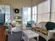 Bright sunroom with wicker furniture and view of backyard at 191 Sweet Cir, Winter Haven, FL 33884