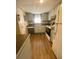 Condo kitchen featuring light gray cabinets and appliances at 1100 Martinique Dr # 208, Winter Haven, FL 33884