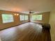 Spacious living room featuring wood-look floors and large windows at 1100 Martinique Dr # 208, Winter Haven, FL 33884