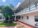 Condo building exterior showing a walkway and landscaping at 1100 Martinique Dr # 208, Winter Haven, FL 33884