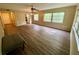 Open living room with wood-look floors and access to kitchen at 1100 Martinique Dr # 208, Winter Haven, FL 33884