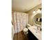 Clean bathroom with shower/tub combo, toilet and vanity with dark wood cabinet at 1100 Martinique Dr # 208, Winter Haven, FL 33884