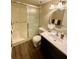 Bathroom with walk-in shower, toilet and dark wood vanity at 1100 Martinique Dr # 208, Winter Haven, FL 33884