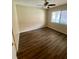 Spacious bedroom with large window, ceiling fan, and wood-look floors at 1100 Martinique Dr # 208, Winter Haven, FL 33884