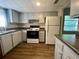 Efficient kitchen with light cabinets and laminate flooring at 1100 Martinique Dr # 208, Winter Haven, FL 33884