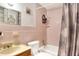 Pink tiled bathroom with shower/tub combo and vanity at 512 N 4Th St, Haines City, FL 33844