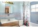 Bathroom with light blue tile, shower/tub combo, and vanity at 512 N 4Th St, Haines City, FL 33844