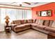 Sunroom with sectional sofa and orange walls at 512 N 4Th St, Haines City, FL 33844
