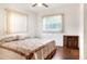 Bedroom with floral comforter and wooden cabinet at 512 N 4Th St, Haines City, FL 33844