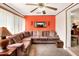 Sunroom with sectional sofa and orange walls at 512 N 4Th St, Haines City, FL 33844