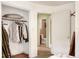 Bedroom closet with clothes hanging and a shelf at 512 N 4Th St, Haines City, FL 33844