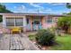Ranch style home with pink exterior, small front yard, and driveway at 512 N 4Th St, Haines City, FL 33844