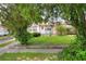 Cute pink house with green landscaping and a yard at 512 N 4Th St, Haines City, FL 33844