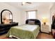 Bedroom with green comforter, dresser, and nightstand at 512 N 4Th St, Haines City, FL 33844