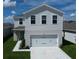 Two-story house with a two-car garage and a neatly landscaped yard at 5031 Starboard St, Haines City, FL 33844